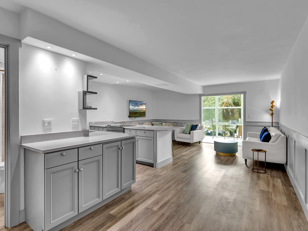 275 Date Palm Road, Unit 304 Vero Beach, FL 32963 - Photo 4 of 36 a kitchen with sink cabinets and wooden floor