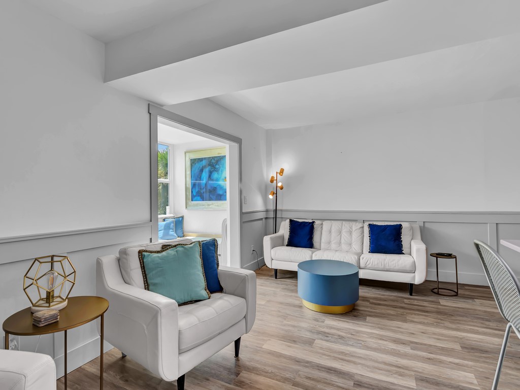 275 Date Palm Road, Unit 304 Vero Beach, FL 32963 - Photo 8 of 36 a living room with furniture and wooden floor