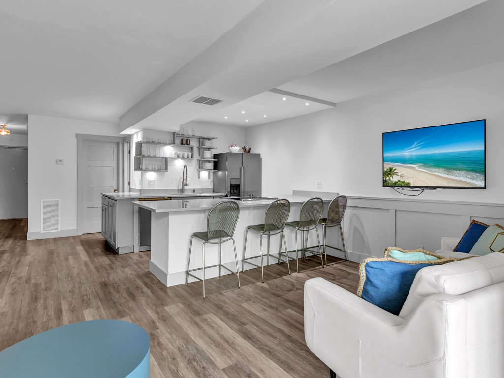 275 Date Palm Road, Unit 304 Vero Beach, FL 32963 - Photo 9 of 36 a living room with furniture and a flat screen tv