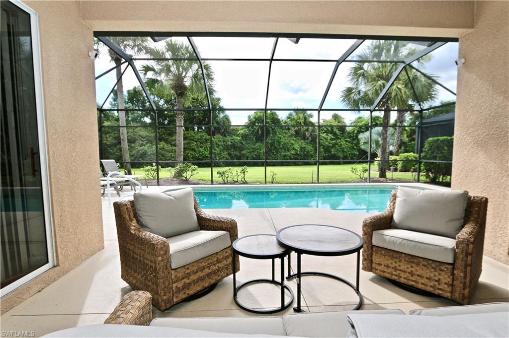 a outdoor living room with furniture and a large window