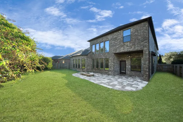 a view of house with backyard and garden