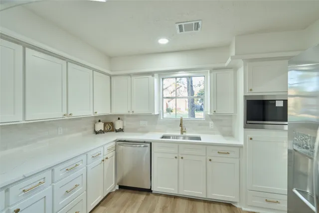 a kitchen with sink cabinets and a window