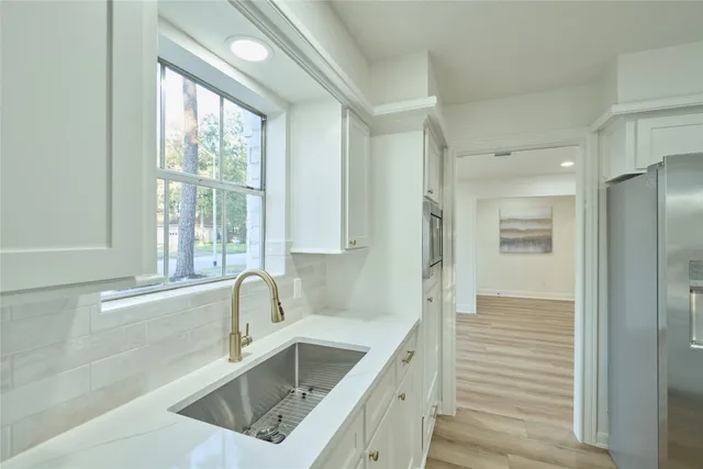 a kitchen with a sink a counter top space and stainless steel appliances