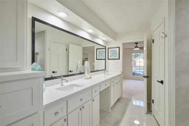 a spacious bathroom with a granite countertop sink mirror and double