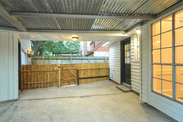 a view of a house with a yard and large tree