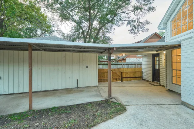 a view of a backyard with a small cabin and a large tree