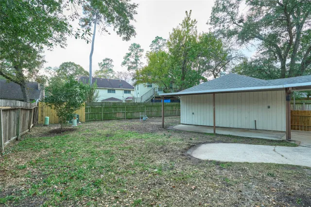 a view of a house with a yard and potted plants