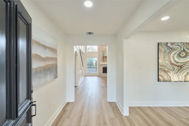 a view of hallway with wooden floor
