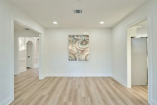 a view of an empty room and wooden floor