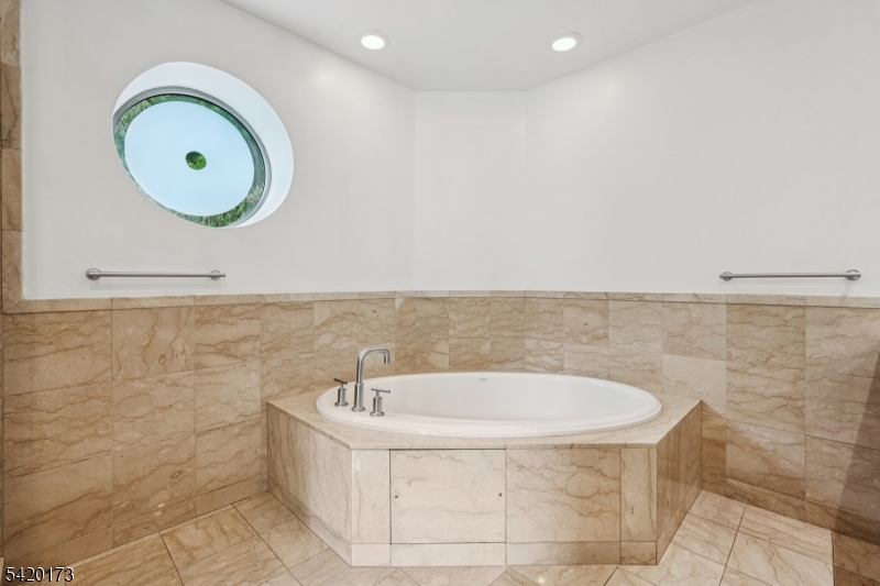 8100 River Road, Unit 210 North Bergen, NJ 07047 - Photo 15 of 25 a bathroom with a bathtub and a sink