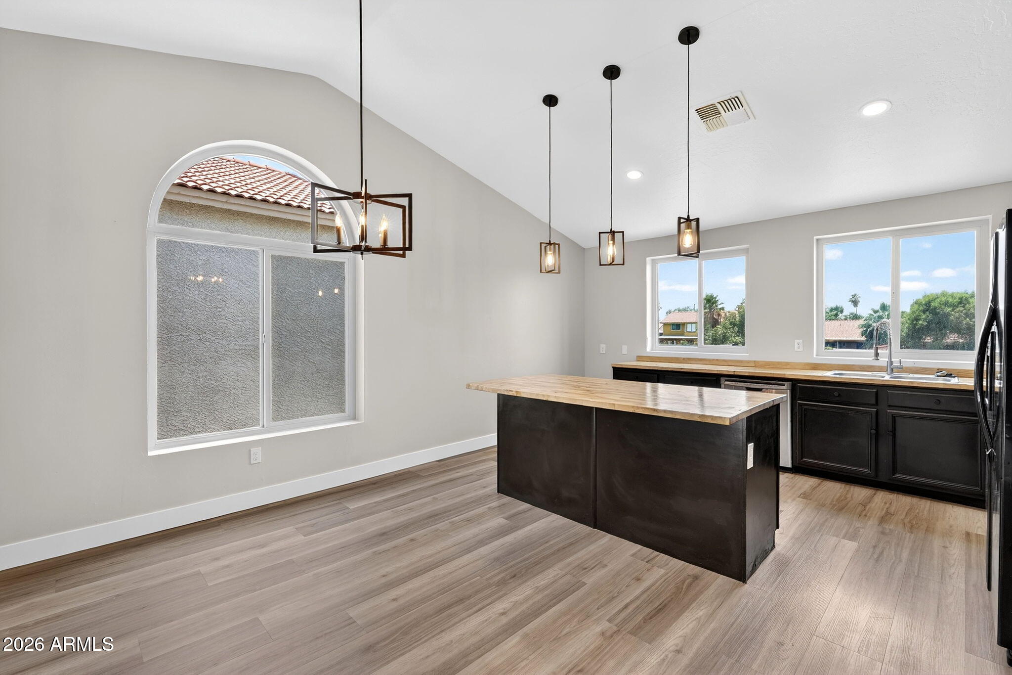 1417 East Mineral Road Gilbert, AZ 85234 - Photo 17 of 59 a kitchen with stainless steel appliances granite countertop a stove a sink and a wooden floor