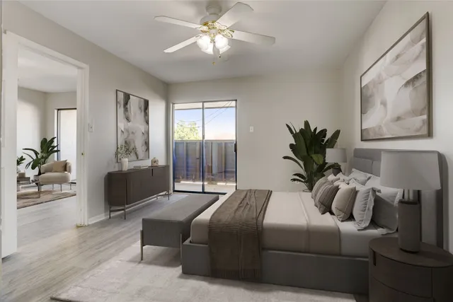 a bedroom with a large bed and a chandelier