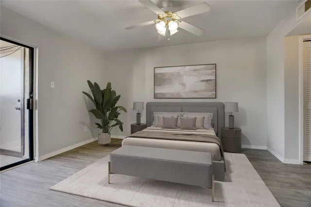 a bedroom with a large bed and a chandelier