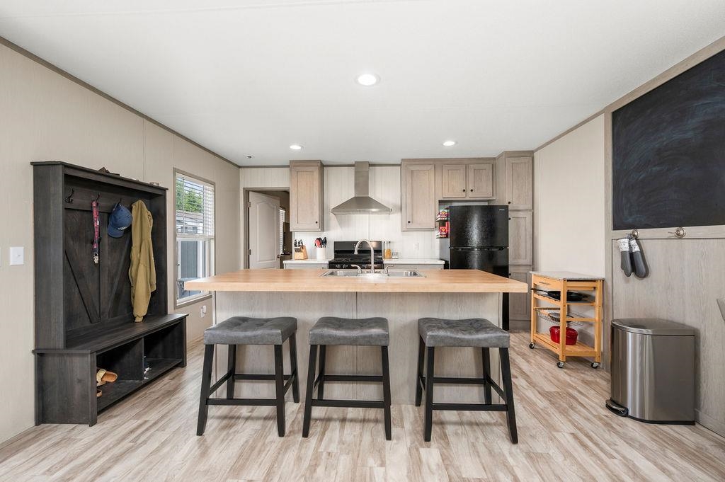 271 Clements Way Fruita, CO 81521 - Photo 6 of 26 a kitchen with stainless steel appliances a table chairs refrigerator and microwave