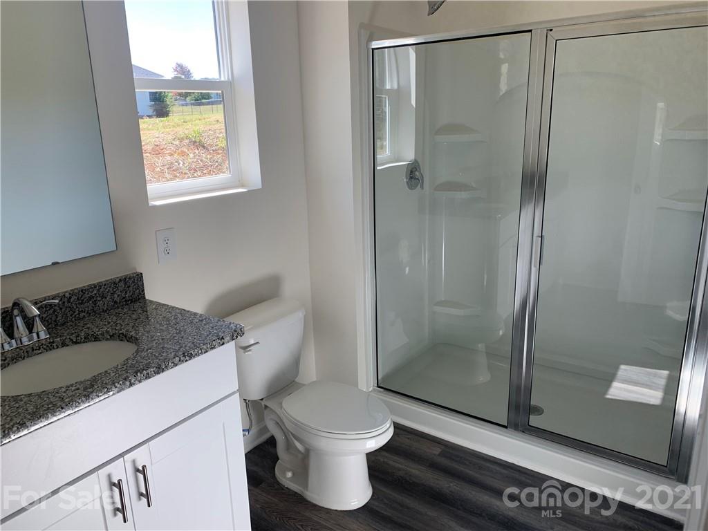 515 3rd Creek Church Road Cleveland, NC 27013 - Photo 4 of 5 a bathroom with a granite countertop sink toilet and shower