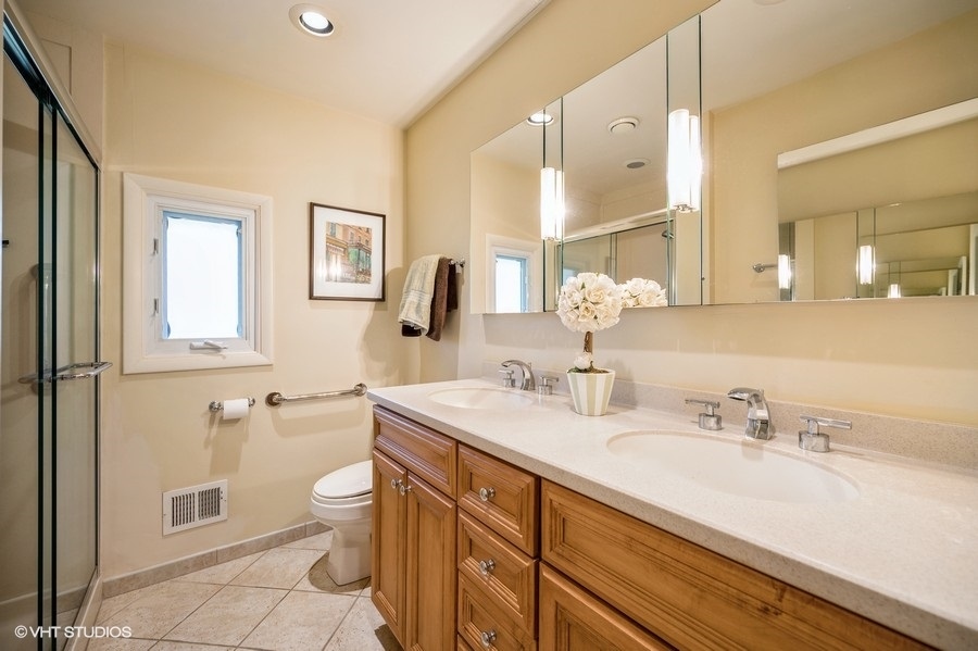 848 Timber Hill Road Highland Park, IL 60035 - Photo 12 of 21 a bathroom with a granite countertop sink mirror vanity and toilet