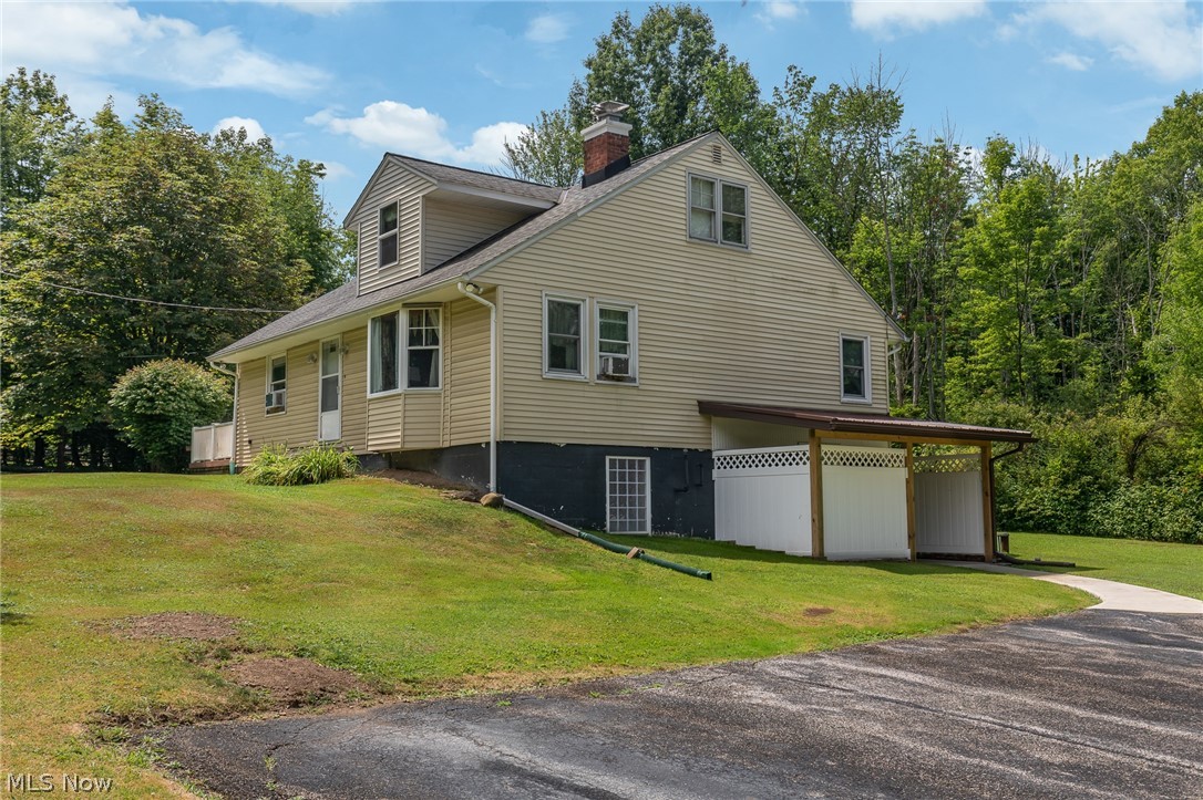 11634 Old State Road Chardon, OH 44024 - Photo 2 of 27 View of side of property exterior with a yard