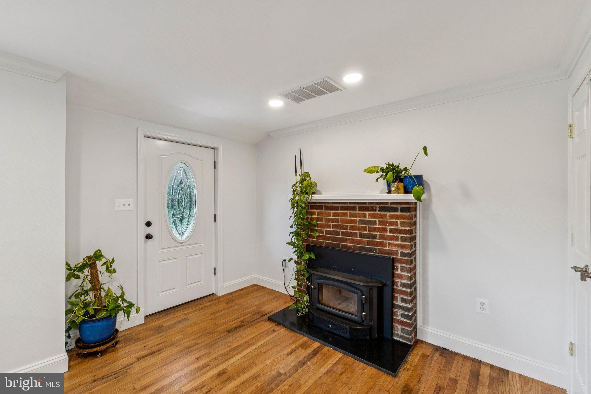 15921 Attleboro Road Silver Spring, MD 20905 - Photo 5 of 43 a living room with furniture and a fireplace