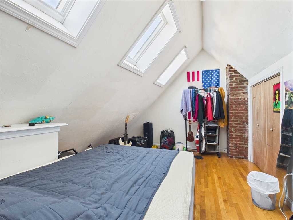 16-22 Reedsdale Street Boston, MA 02134 - Photo 15 of 39 a bed room with a bed and a television