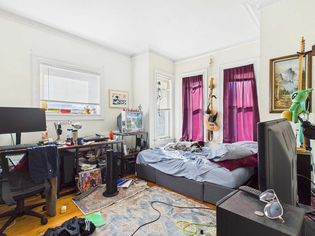 16-22 Reedsdale Street Boston, MA 02134 - Photo 17 of 39 a living room with lots of furniture and gym equipment