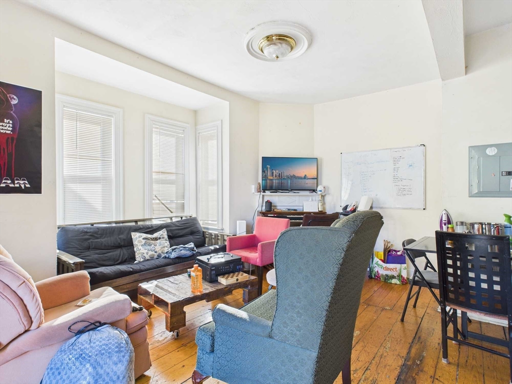 16-22 Reedsdale Street Boston, MA 02134 - Photo 18 of 39 a living room with furniture and a flat screen tv