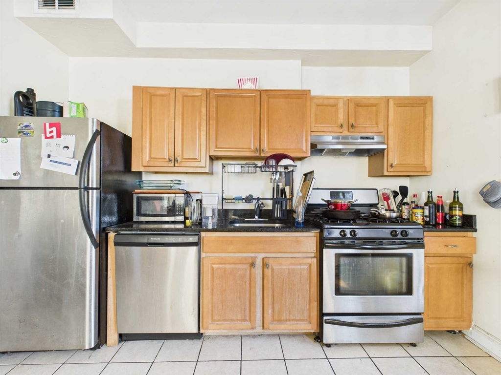 16-22 Reedsdale Street Boston, MA 02134 - Photo 20 of 39 a kitchen with white cabinets and white appliances