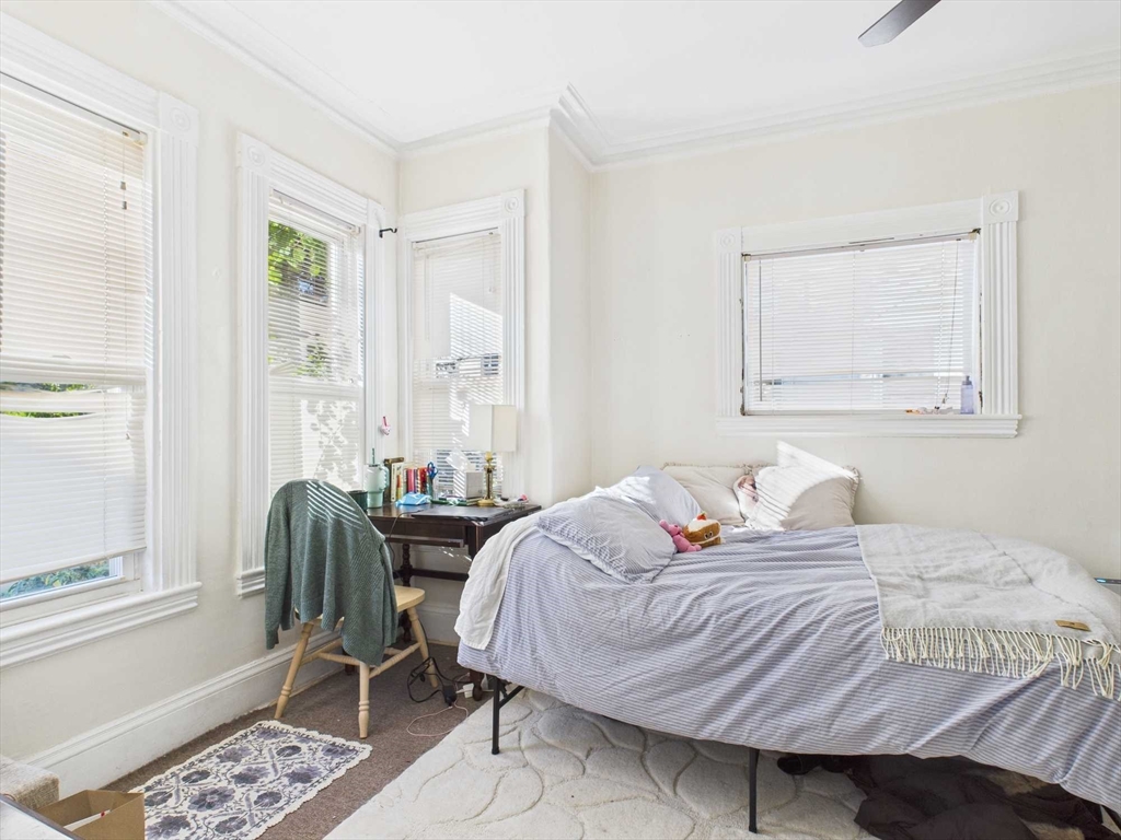 16-22 Reedsdale Street Boston, MA 02134 - Photo 33 of 39 a bedroom with a bed and wooden floor