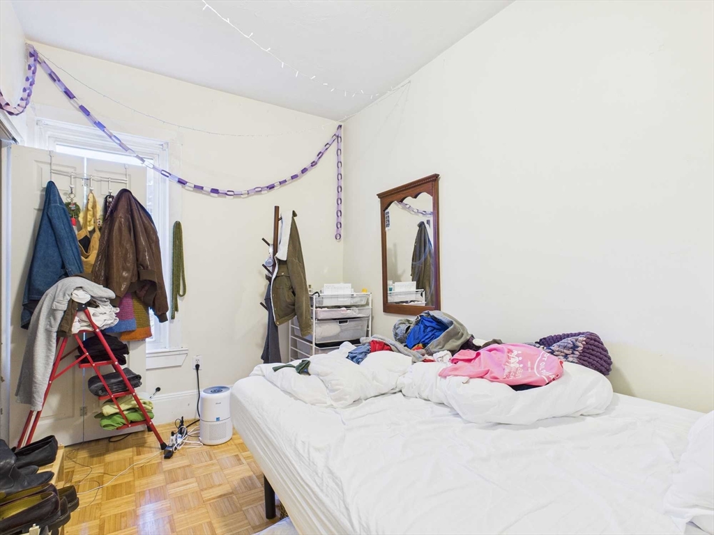 16-22 Reedsdale Street Boston, MA 02134 - Photo 34 of 39 a bedroom with a bed and a closet