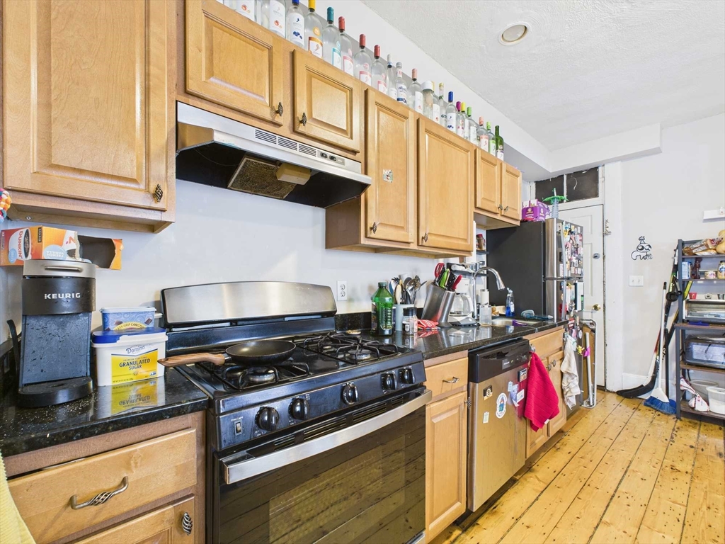 16-22 Reedsdale Street Boston, MA 02134 - Photo 7 of 39 a kitchen with stainless steel appliances granite countertop a stove and cabinets