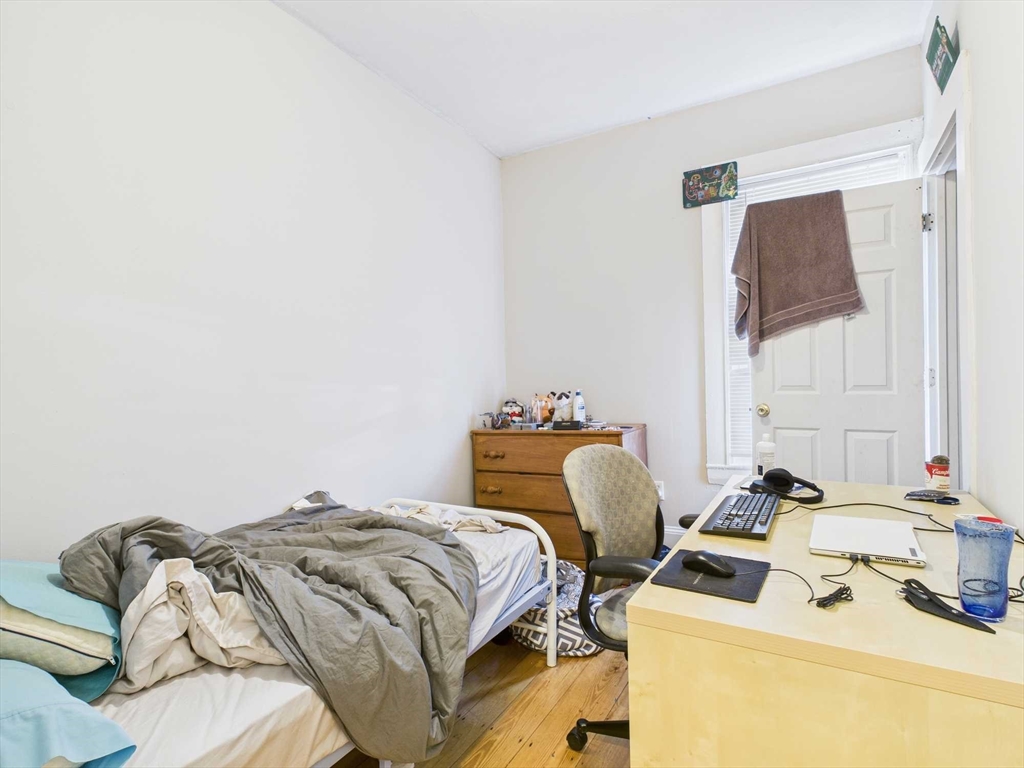 16-22 Reedsdale Street Boston, MA 02134 - Photo 9 of 39 a bedroom with a bed and dresser