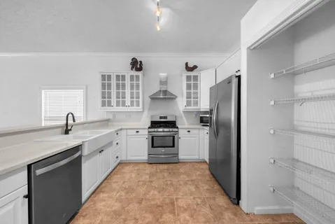 a kitchen with stainless steel appliances a stove a refrigerator and a sink
