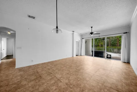 a view of a room with furniture and large windows