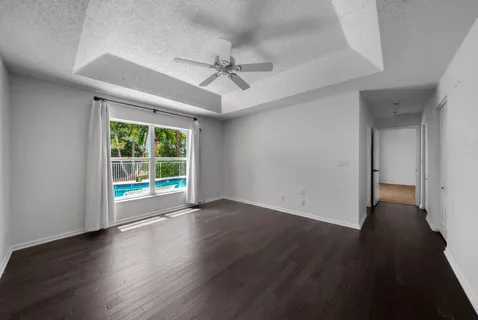 a view of a room with wooden floor and white walls