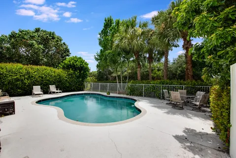 a view of a white house with a swimming pool