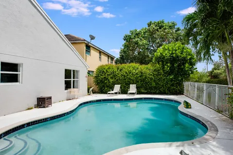 a view of a backyard with swimming pool