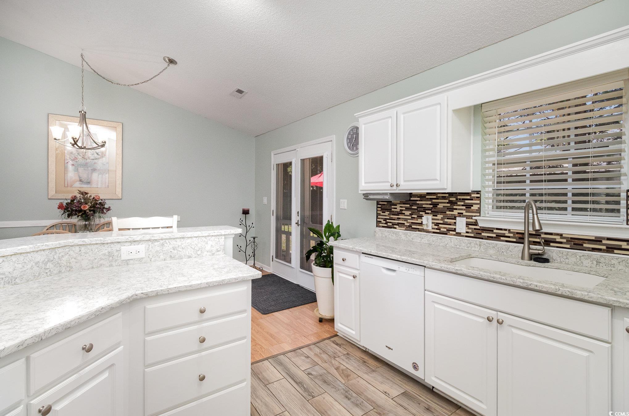 2654 Wild Game Trail Myrtle Beach, SC 29588 - Photo 12 of 37 Kitchen with a notable chandelier, dishwasher, a s