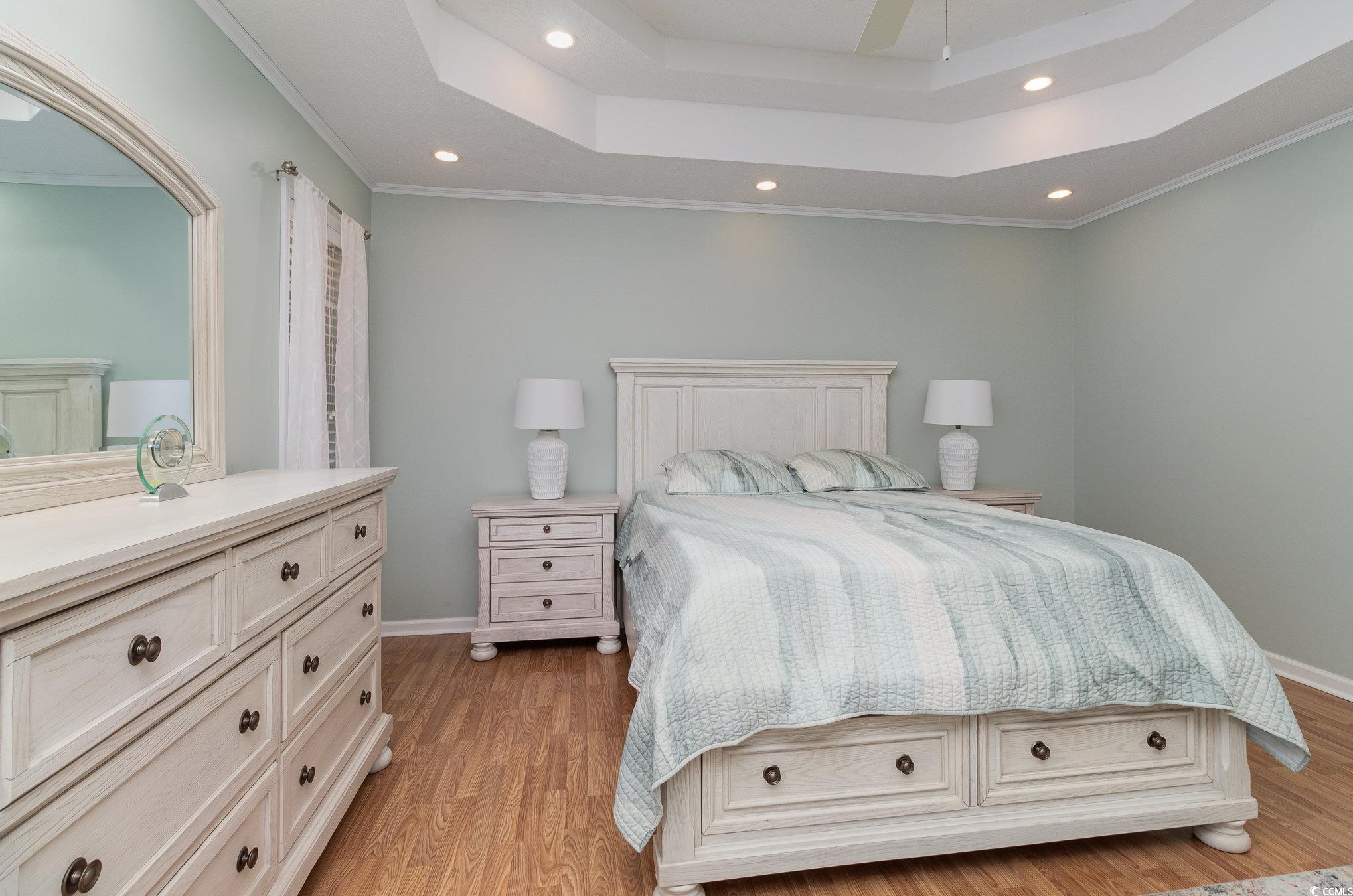 2654 Wild Game Trail Myrtle Beach, SC 29588 - Photo 16 of 37 Bedroom featuring a tray ceiling, light wood finis