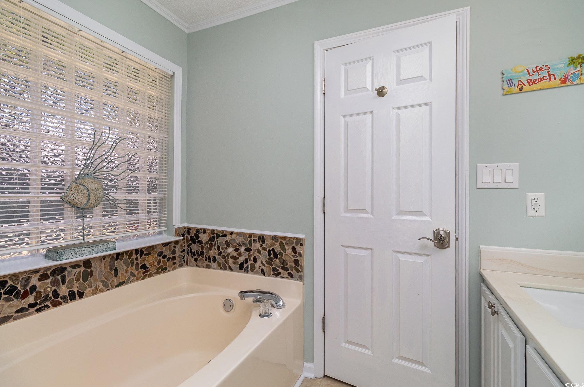 2654 Wild Game Trail Myrtle Beach, SC 29588 - Photo 19 of 37 Full bathroom featuring a bath, vanity, and crown
