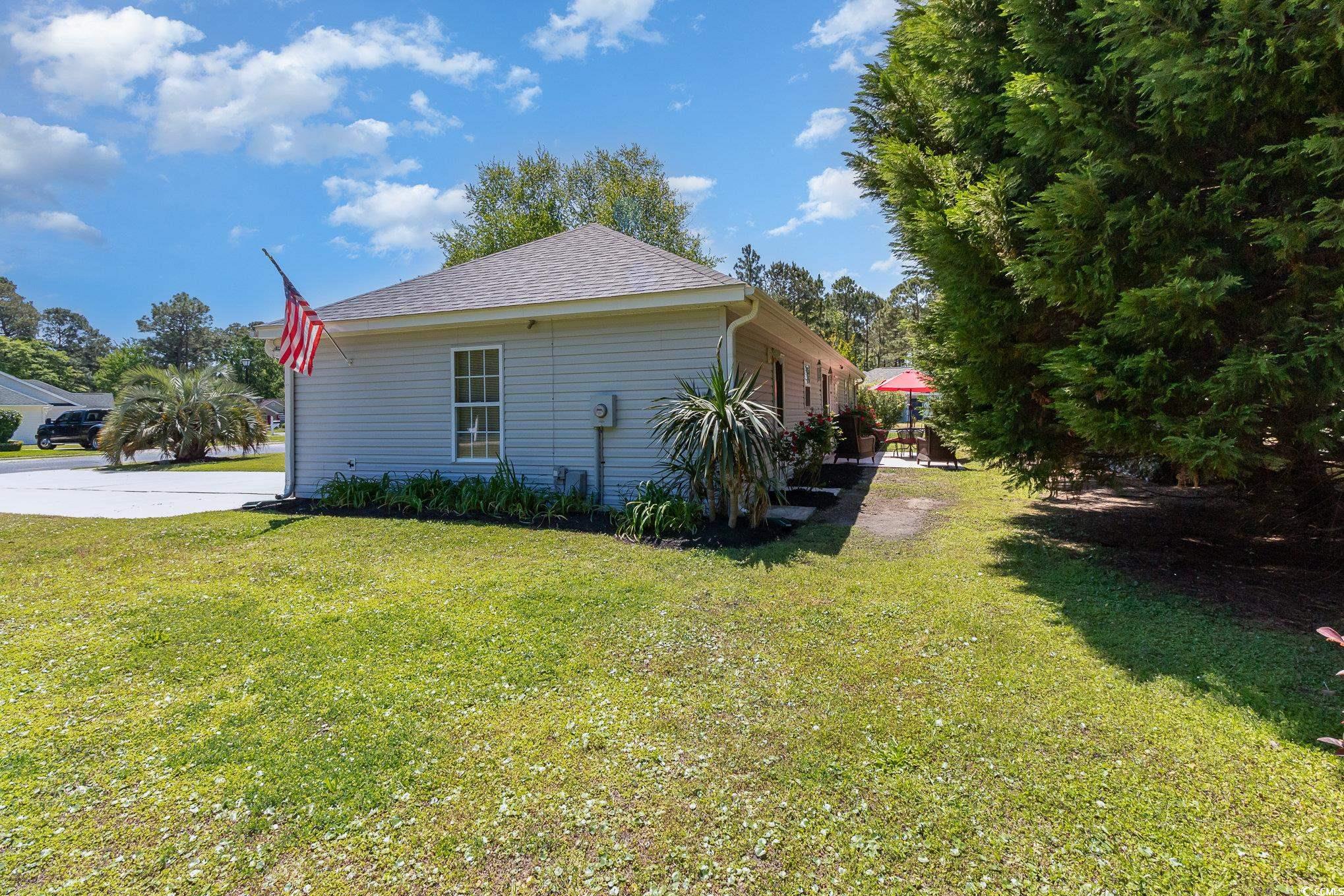 2654 Wild Game Trail Myrtle Beach, SC 29588 - Photo 29 of 37 View of side of home featuring a yard and roof wit