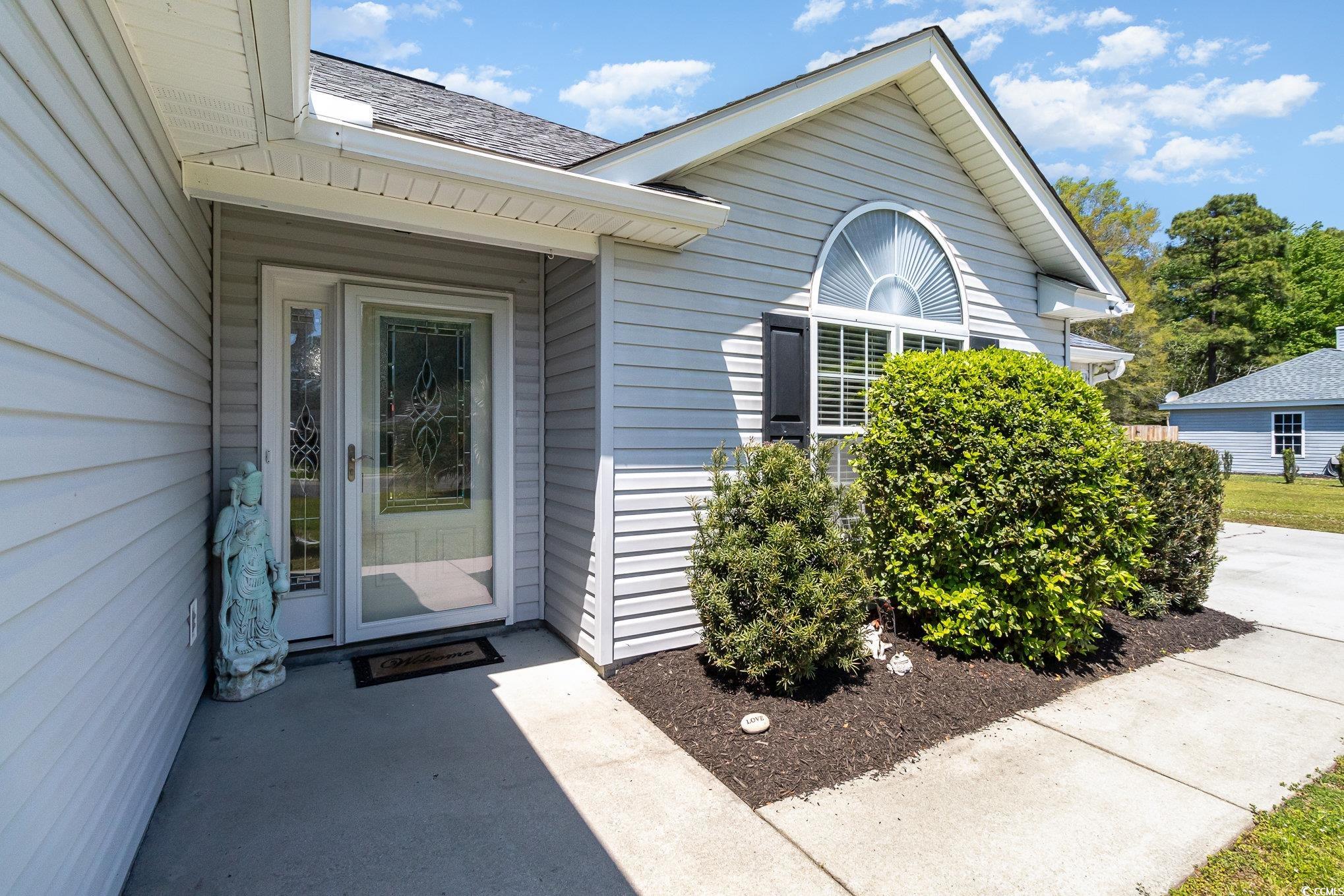 2654 Wild Game Trail Myrtle Beach, SC 29588 - Photo 4 of 37 View of exterior entry featuring a shingled roof