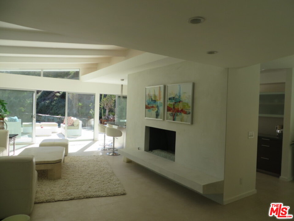 9659 Cedarbrook Drive Beverly Hills, CA 90210 - Photo 3 of 21 a living room with furniture and a fireplace