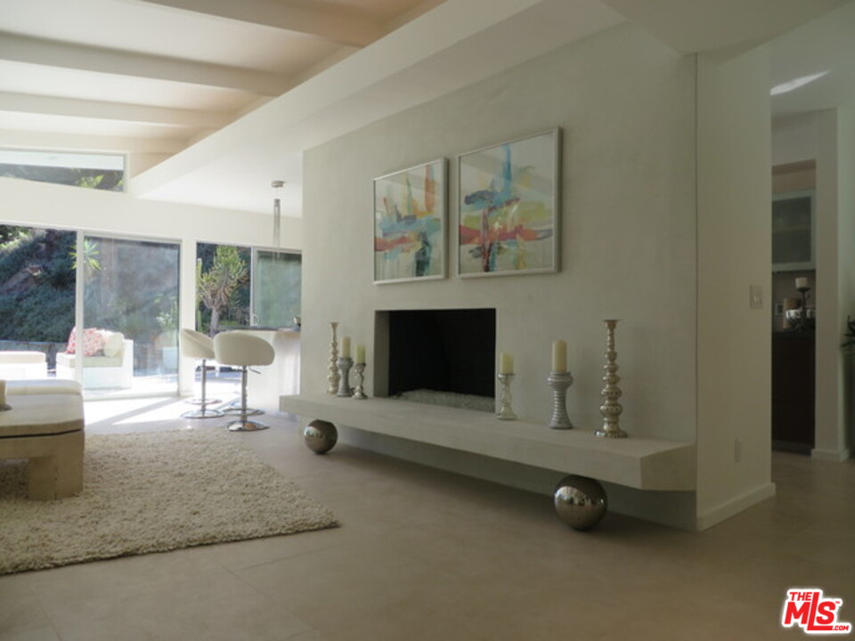 9659 Cedarbrook Drive Beverly Hills, CA 90210 - Photo 6 of 21 a living room with furniture and a fireplace