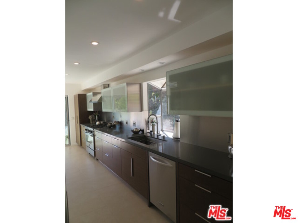 9659 Cedarbrook Drive Beverly Hills, CA 90210 - Photo 10 of 21 a large bathroom with a double vanity sink and a mirror