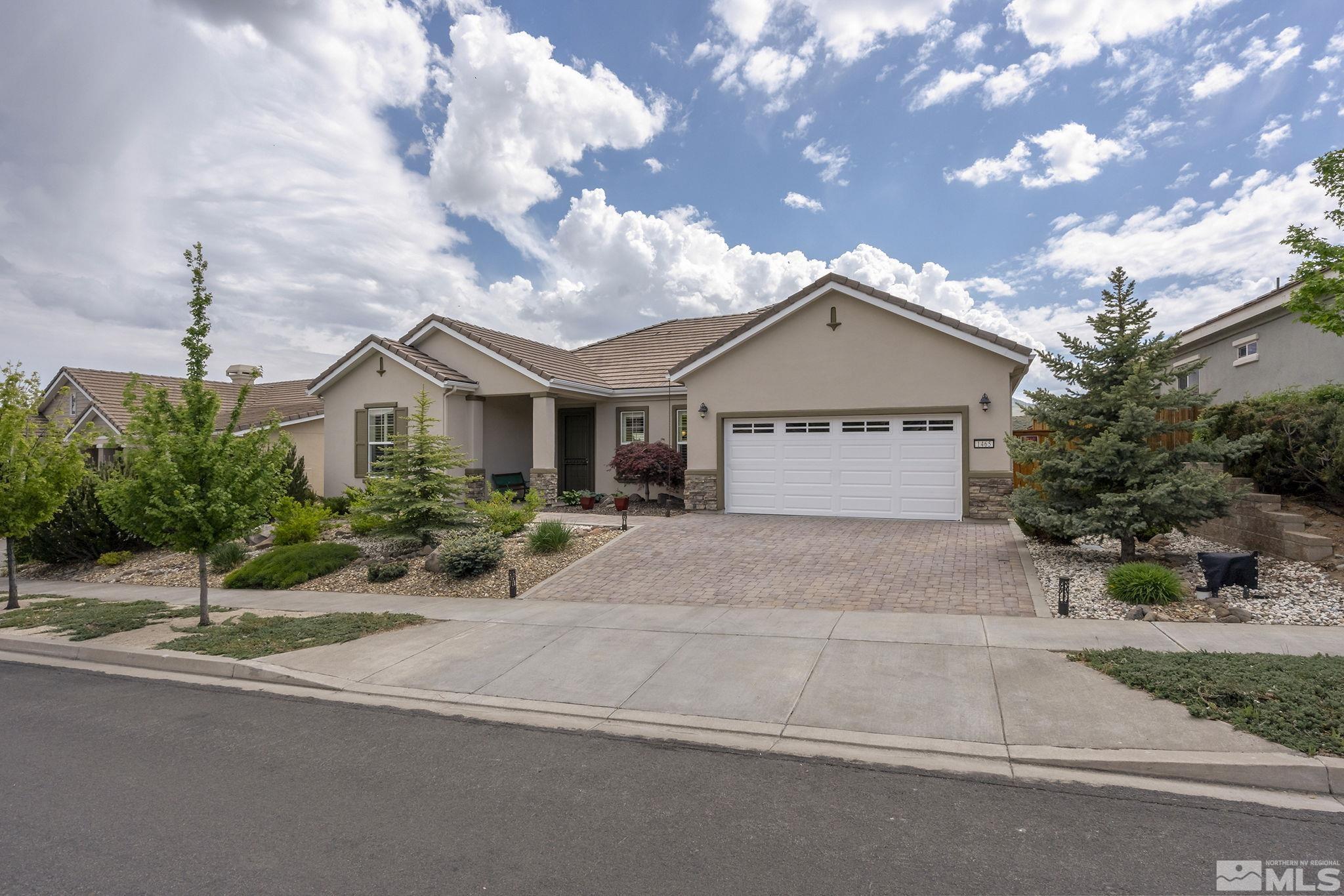 1465 Meridian Ranch Drive Reno, NV 89523 - Photo 2 of 40 a front view of a house with a yard and garage