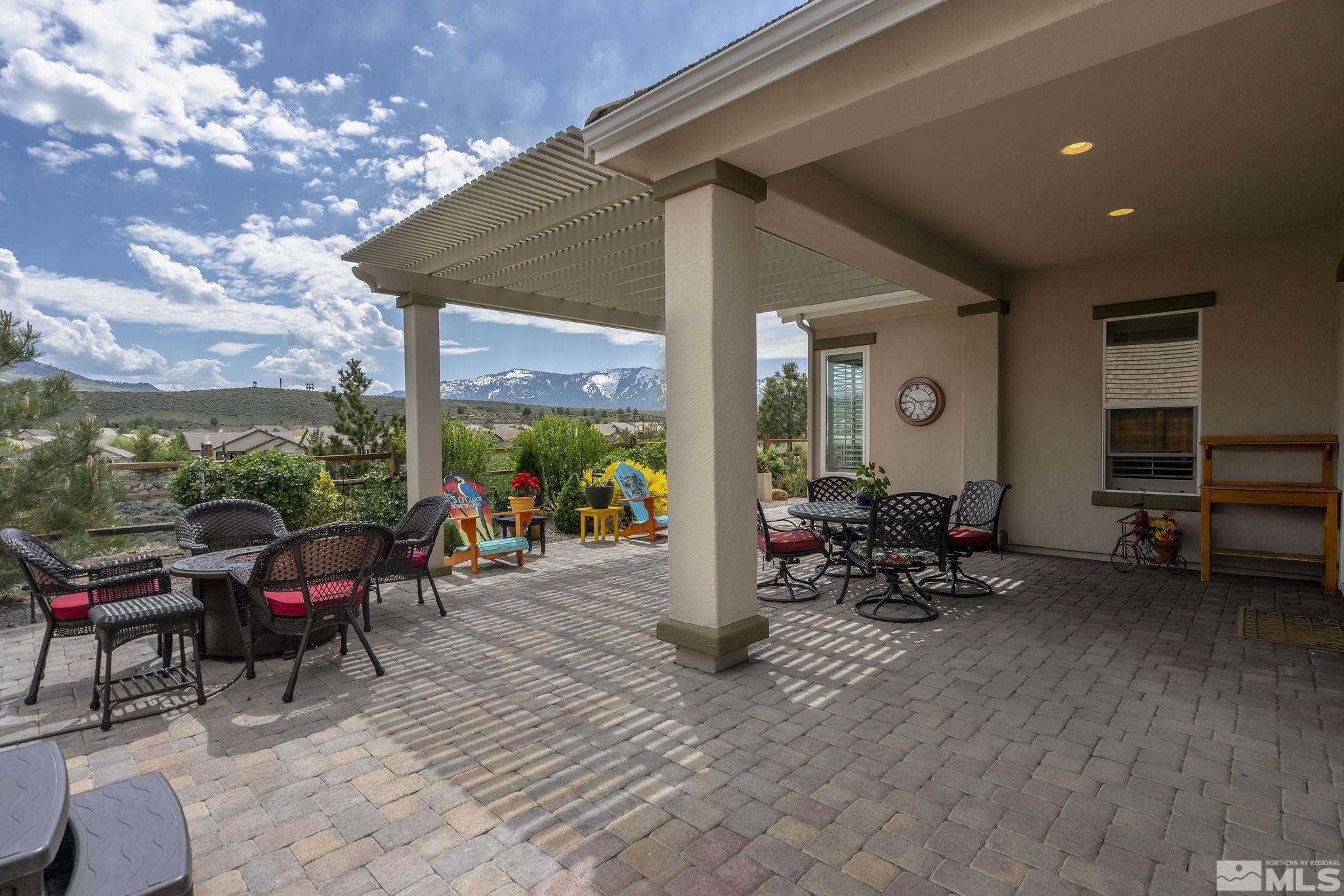 1465 Meridian Ranch Drive Reno, NV 89523 - Photo 25 of 40 a view of a patio with table and chairs and floor to ceiling window