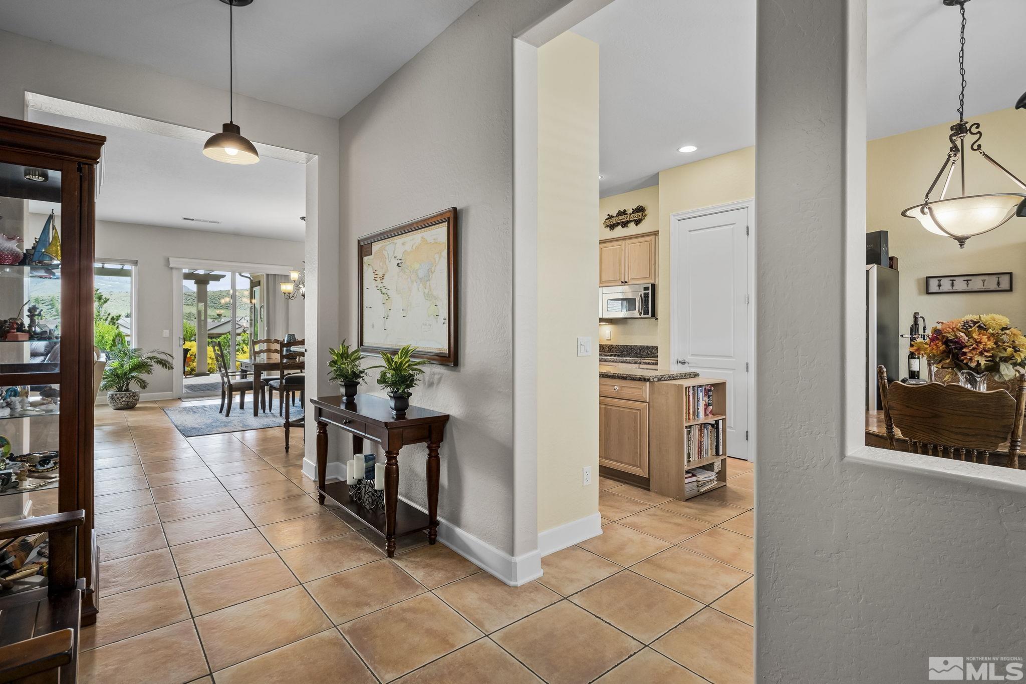 1465 Meridian Ranch Drive Reno, NV 89523 - Photo 3 of 40 a view of a hallway with dining room and furniture
