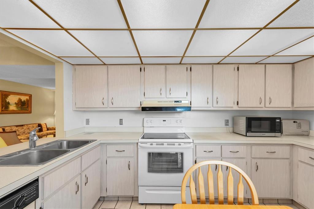 12300 Vonn Road, Unit 4101 Largo, FL 33774 - Photo 12 of 46 a kitchen with stainless steel appliances granite countertop a sink a stove and cabinets