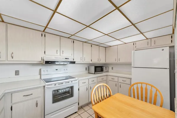 a view of a kitchen counter space a stove and cabinets