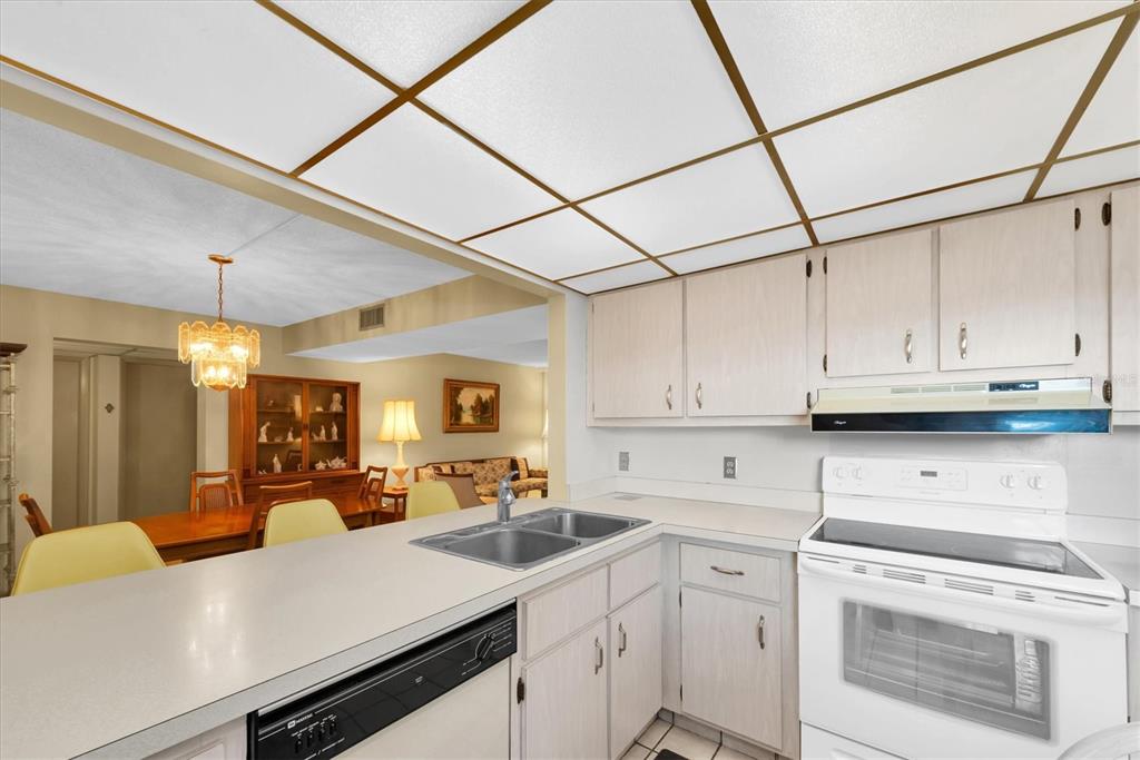12300 Vonn Road, Unit 4101 Largo, FL 33774 - Photo 14 of 46 a view of a kitchen counter space a stove and cabinets