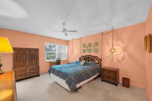 a bedroom with a bed and a dresser in it
